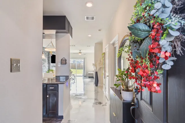 a large white kitchen with sink and refrigerator