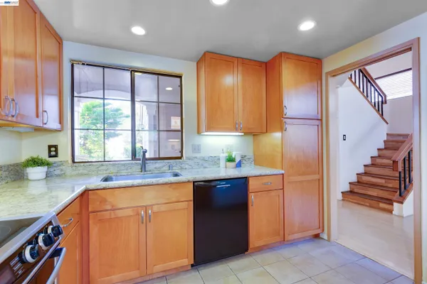 a kitchen with stainless steel appliances granite countertop a sink and a stove