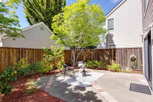 a view of house with backyard and sitting area