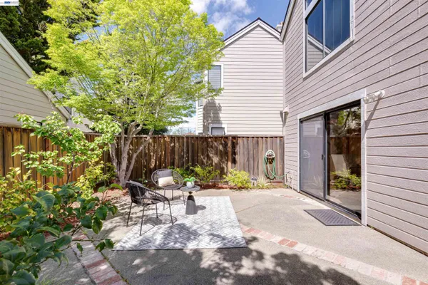 a backyard of a house with table and chairs