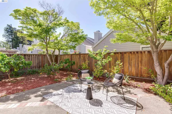a view of a patio with table and chairs and potted plants