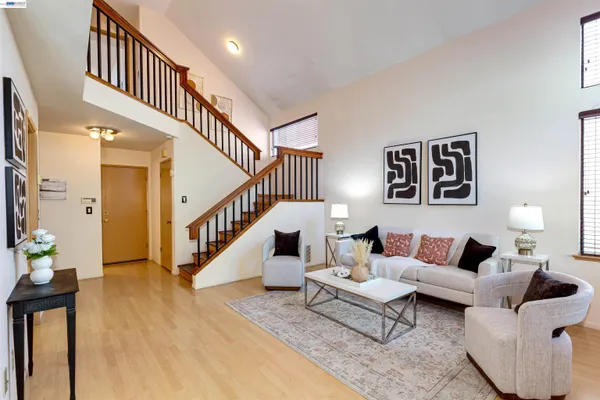 a living room with furniture and stairs
