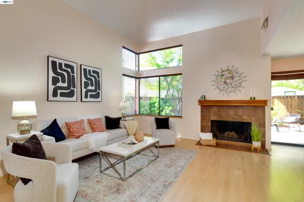 a living room with furniture and a fireplace