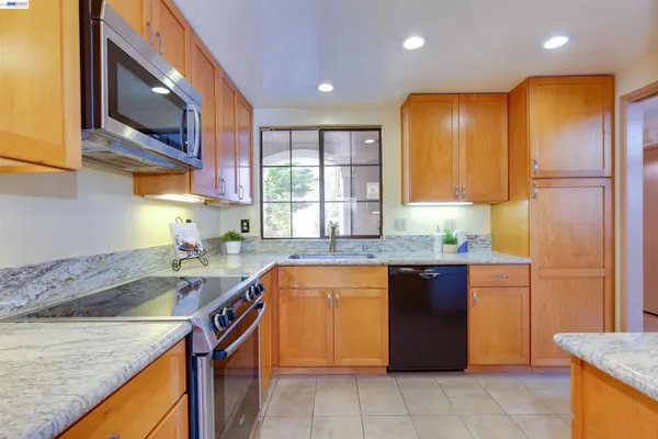 a kitchen with a sink stove and cabinets