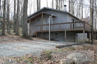 907 Pine Ridge Road Beech Mountain, NC 28604 - Photo 1 of 1 a wooden house with a large window and wooden fence
