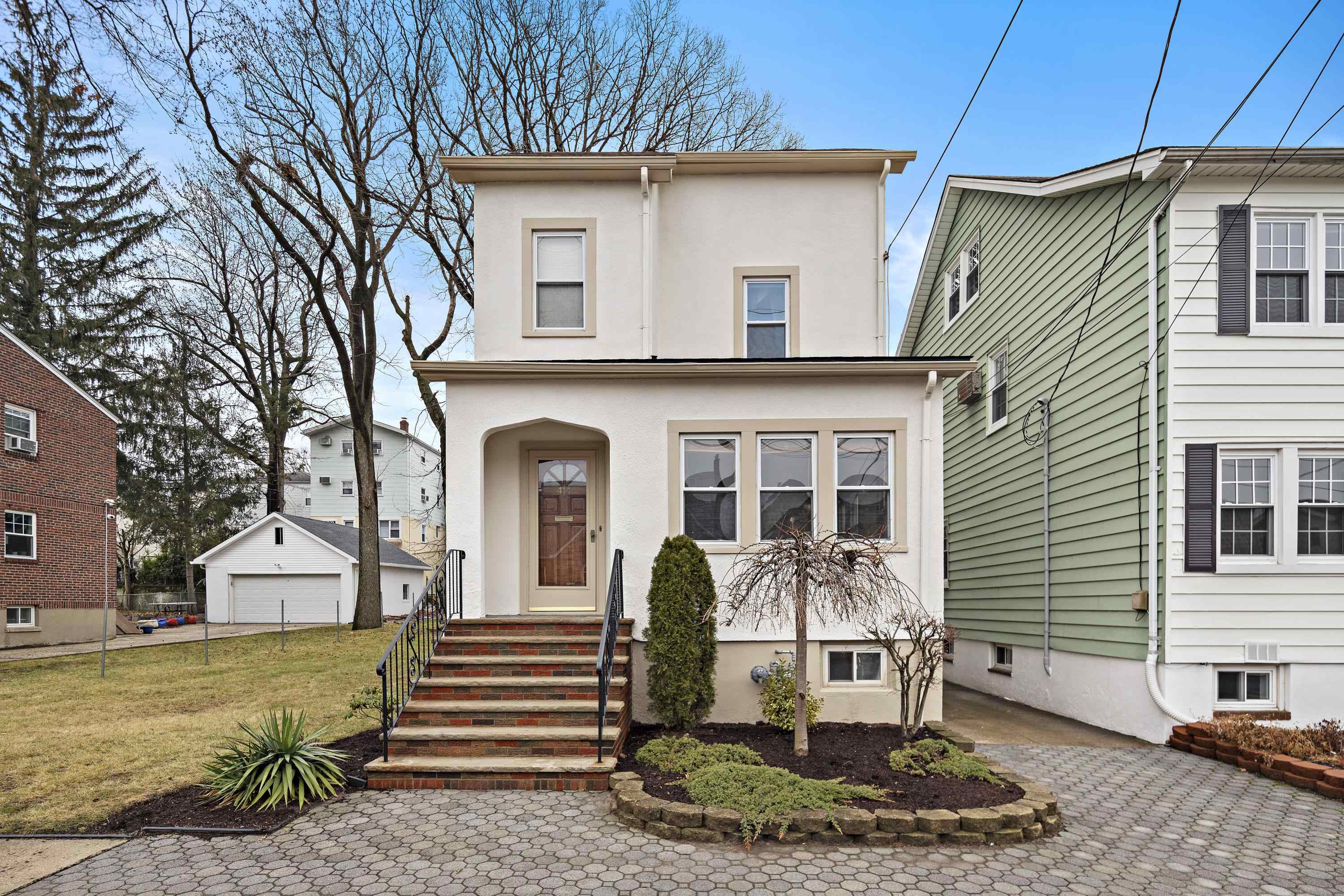 a front view of a house with garden
