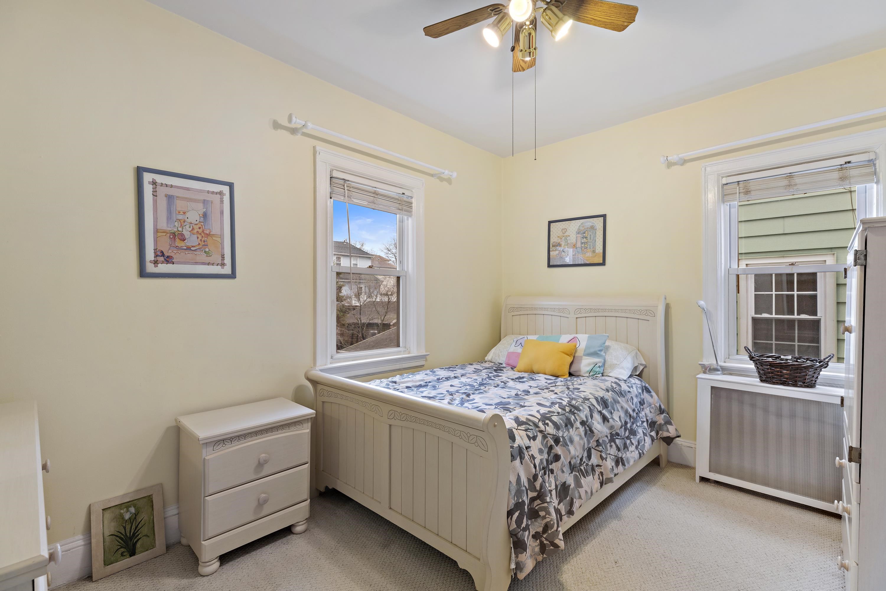 414 North 8th Street Fairview, NJ 07022 - Photo 11 of 22 a bedroom with a bed and a chandelier