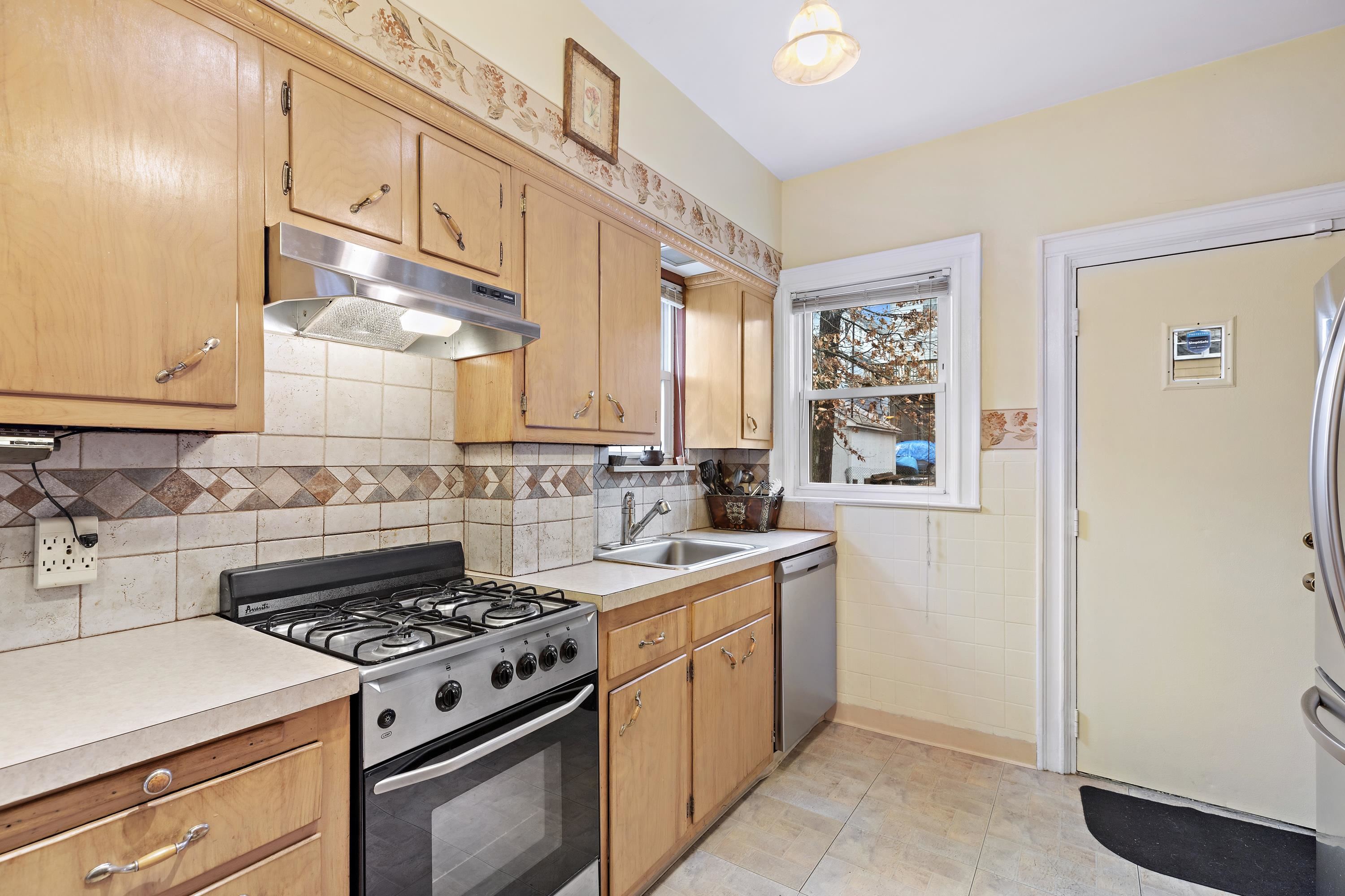 414 North 8th Street Fairview, NJ 07022 - Photo 17 of 22 a kitchen with a stove and a refrigerator