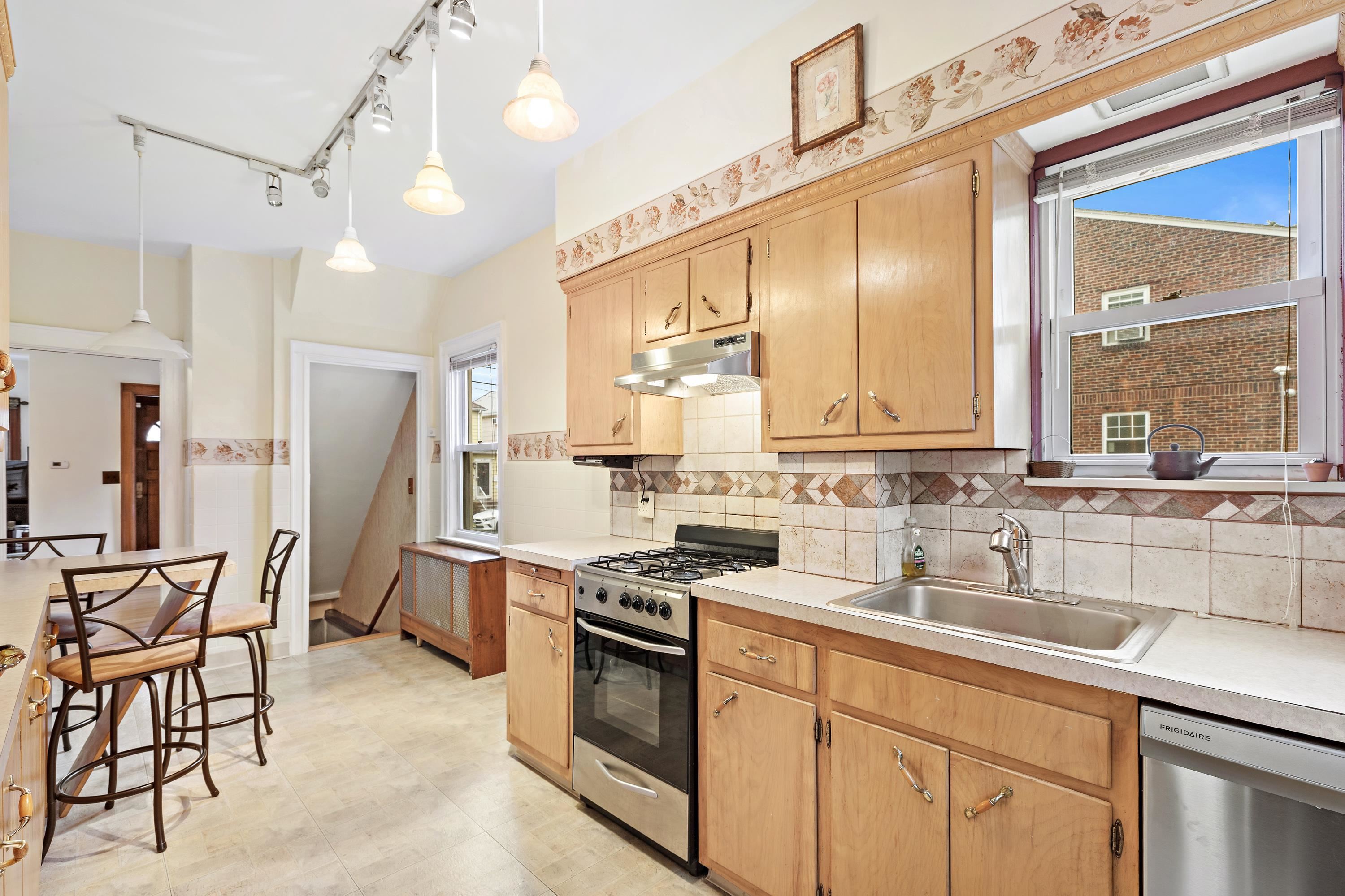 414 North 8th Street Fairview, NJ 07022 - Photo 18 of 22 a kitchen with stainless steel appliances a sink stove and cabinets