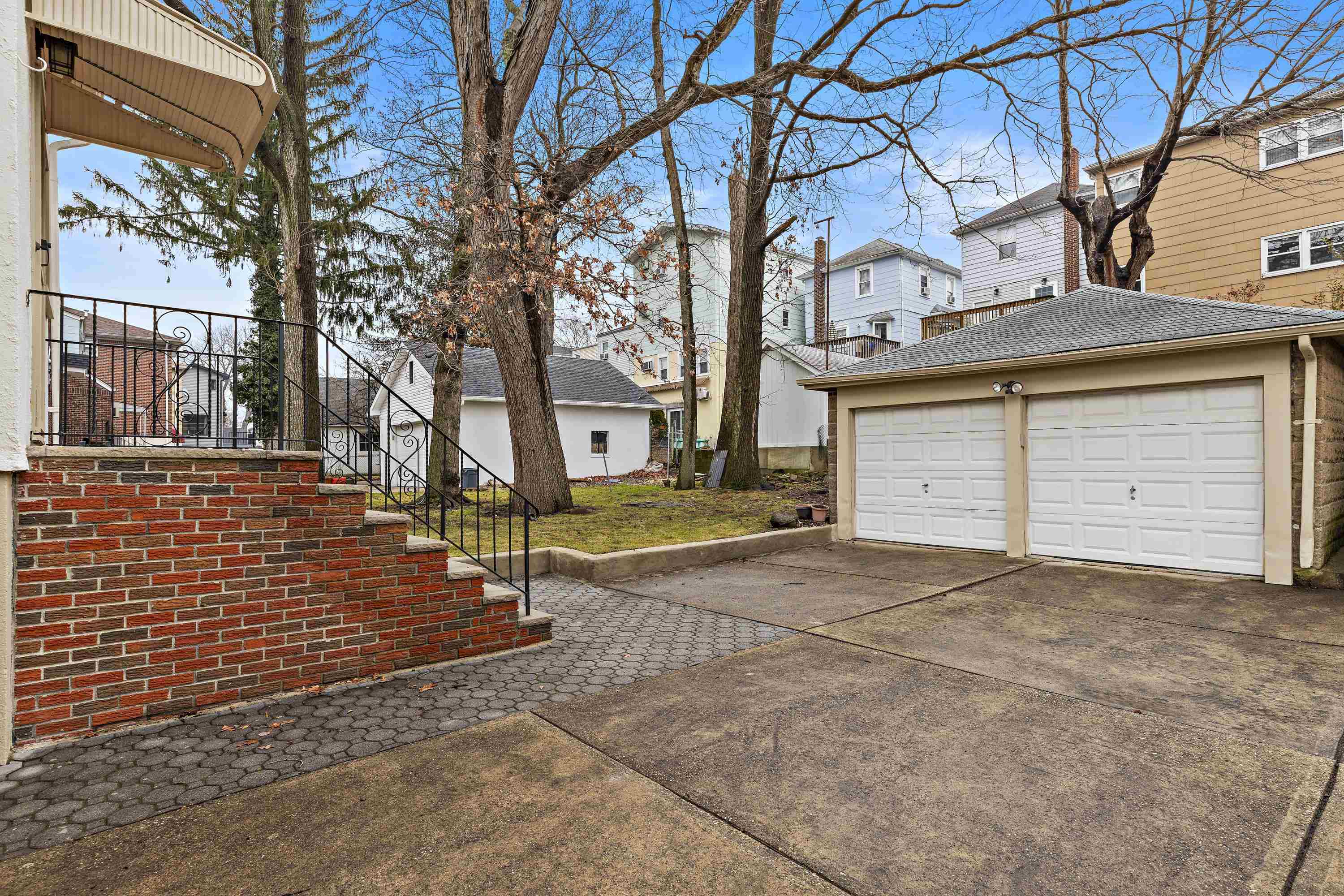 414 North 8th Street Fairview, NJ 07022 - Photo 3 of 22 a view of a brick house with large windows and a tree