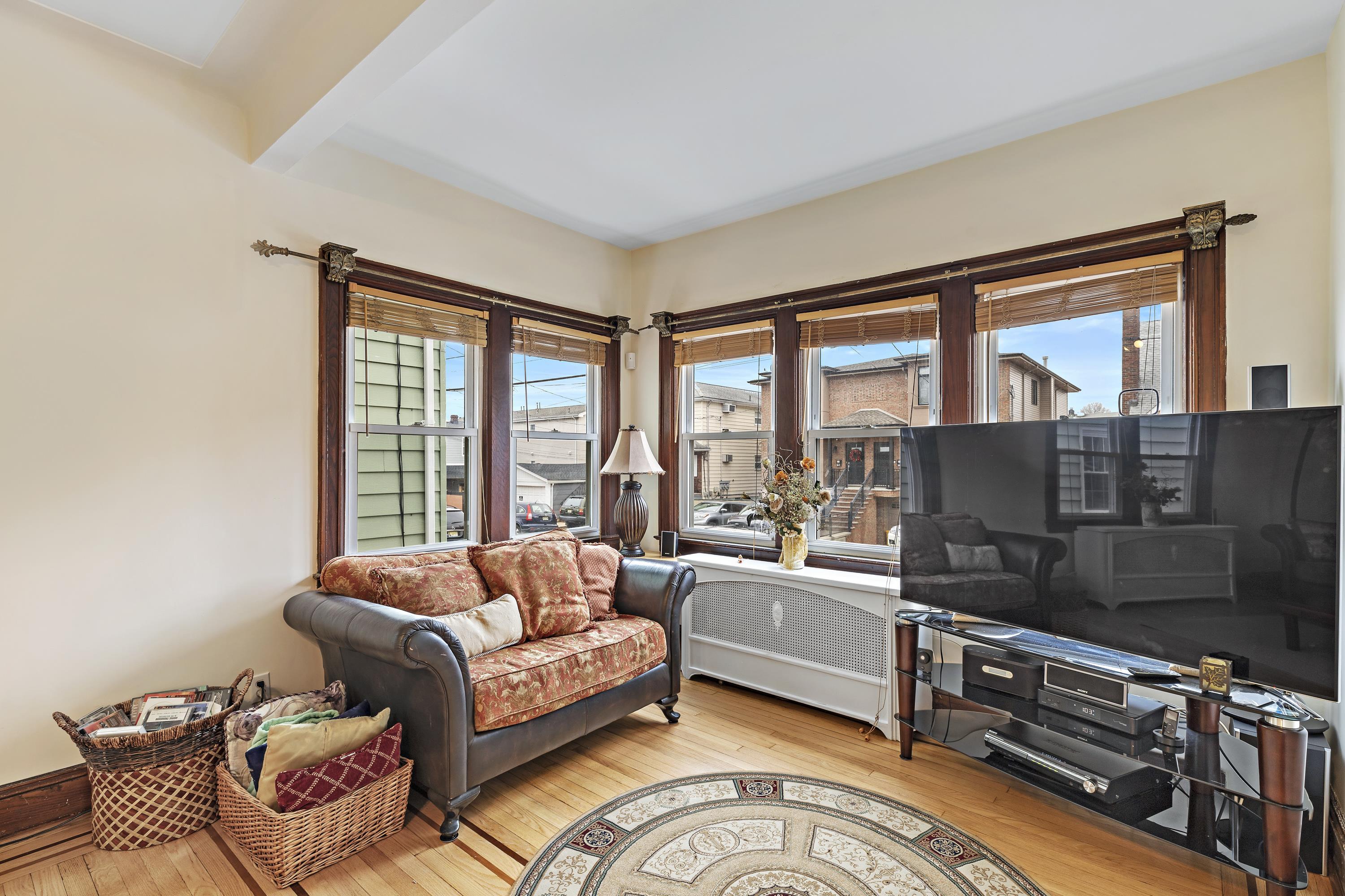 414 North 8th Street Fairview, NJ 07022 - Photo 6 of 22 a living room with furniture and a floor to ceiling window