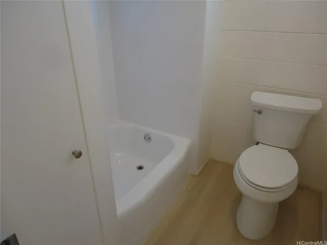 a white toilet sitting next to a sink