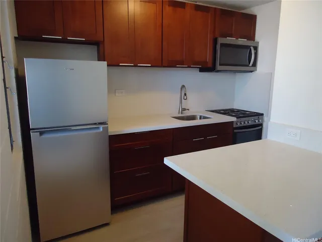 a kitchen with a refrigerator and a microwave