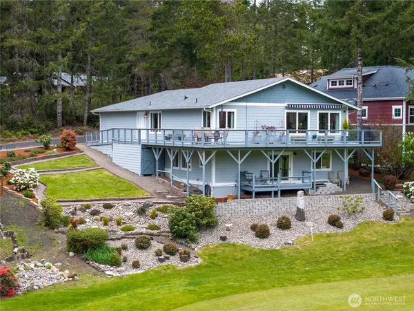 a aerial view of a house with swimming pool lawn chairs and a yard