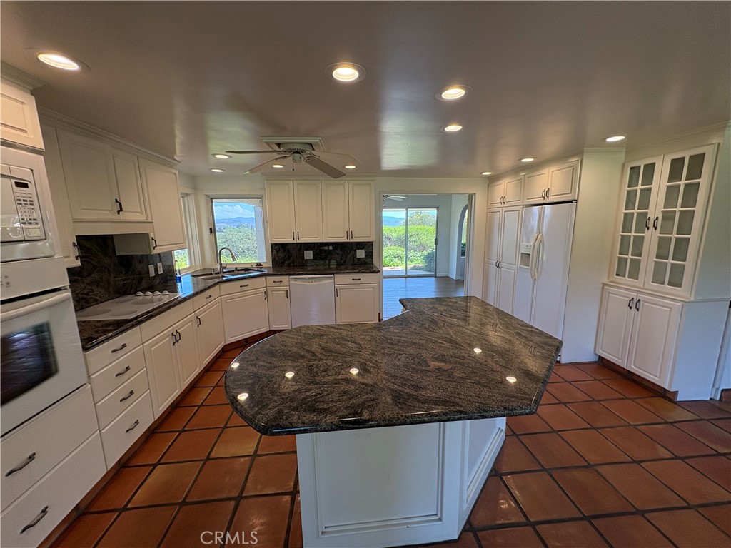1905 Vista Del Norte Fallbrook, CA 92028 - Photo 12 of 29 a kitchen with kitchen island granite countertop a sink and cabinets