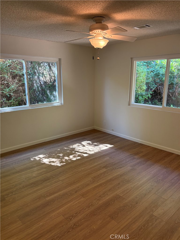 1905 Vista Del Norte Fallbrook, CA 92028 - Photo 24 of 29 a view of empty room with wooden floor and fan