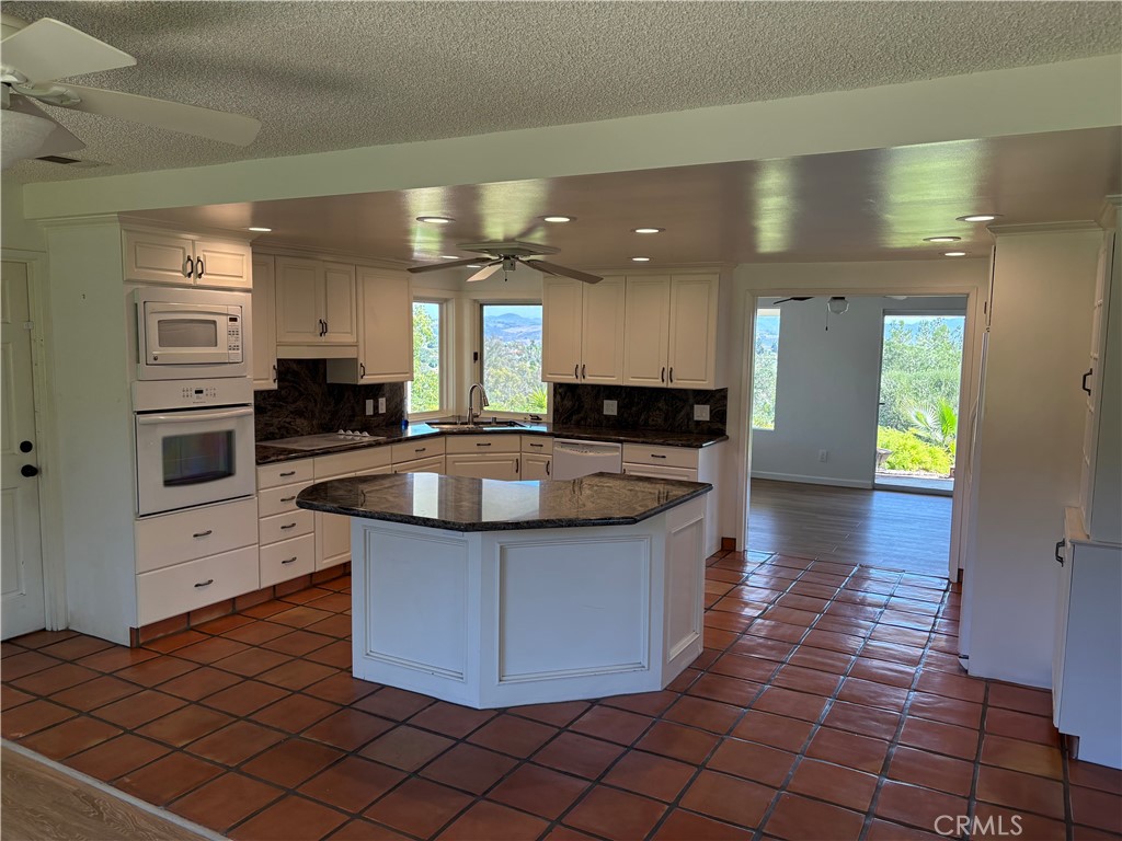 1905 Vista Del Norte Fallbrook, CA 92028 - Photo 5 of 29 a kitchen with stainless steel appliances granite countertop a sink and a stove