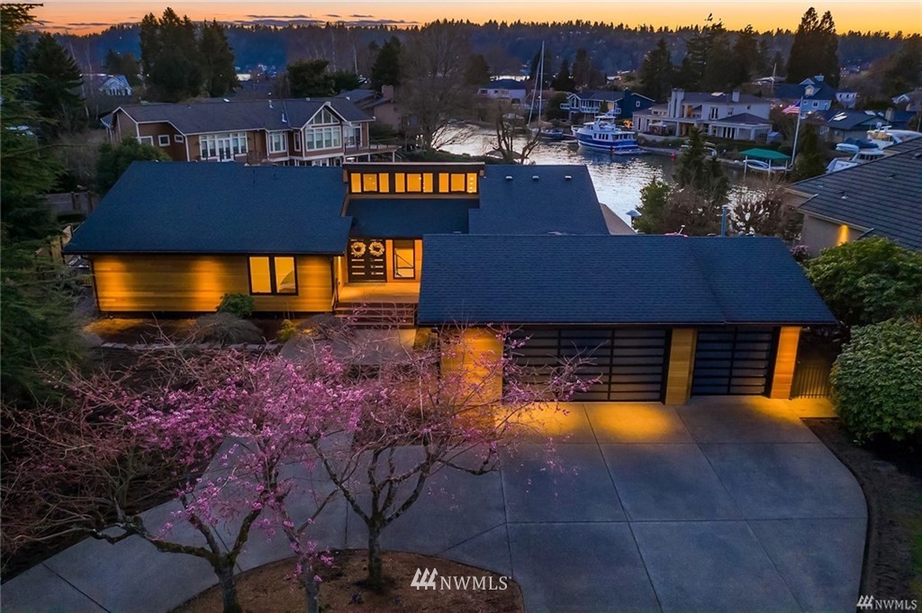 a view of a house with pool and a yard
