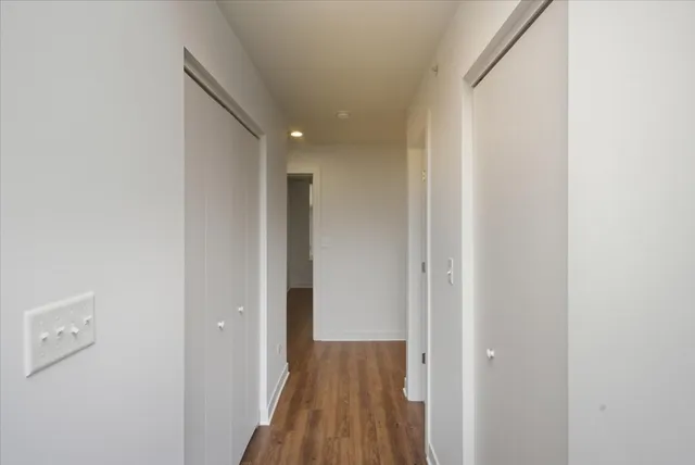 a view of a hallway with wooden floor