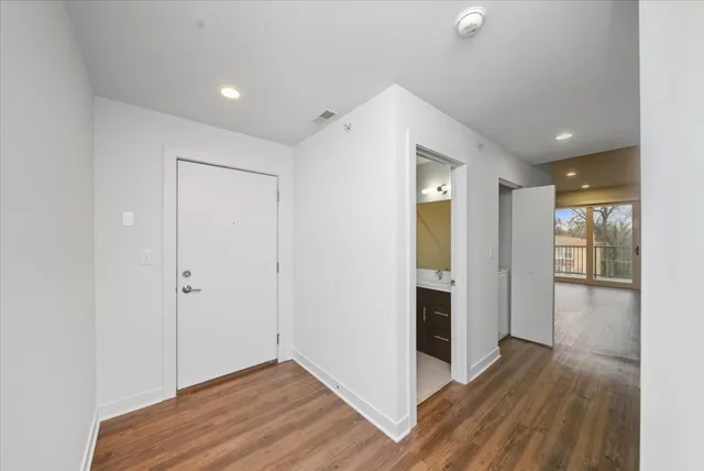 a view of hallway with wooden floor