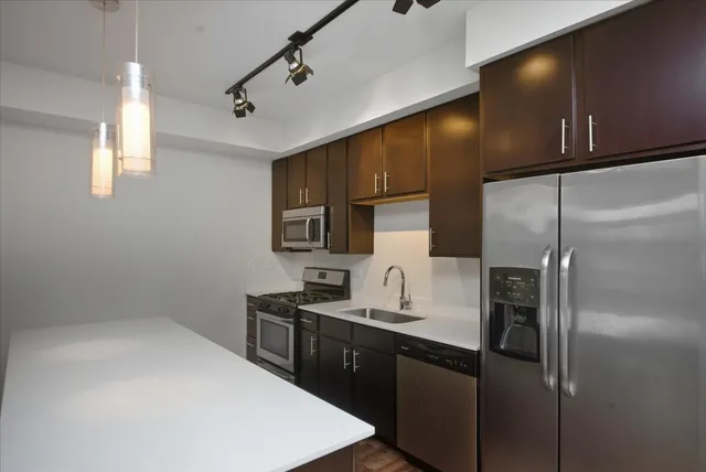 a kitchen with stainless steel appliances a refrigerator and a sink