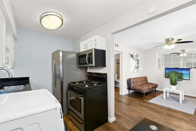 a kitchen with a sink and a stove top oven