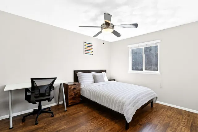 a bedroom with a bed and a chair