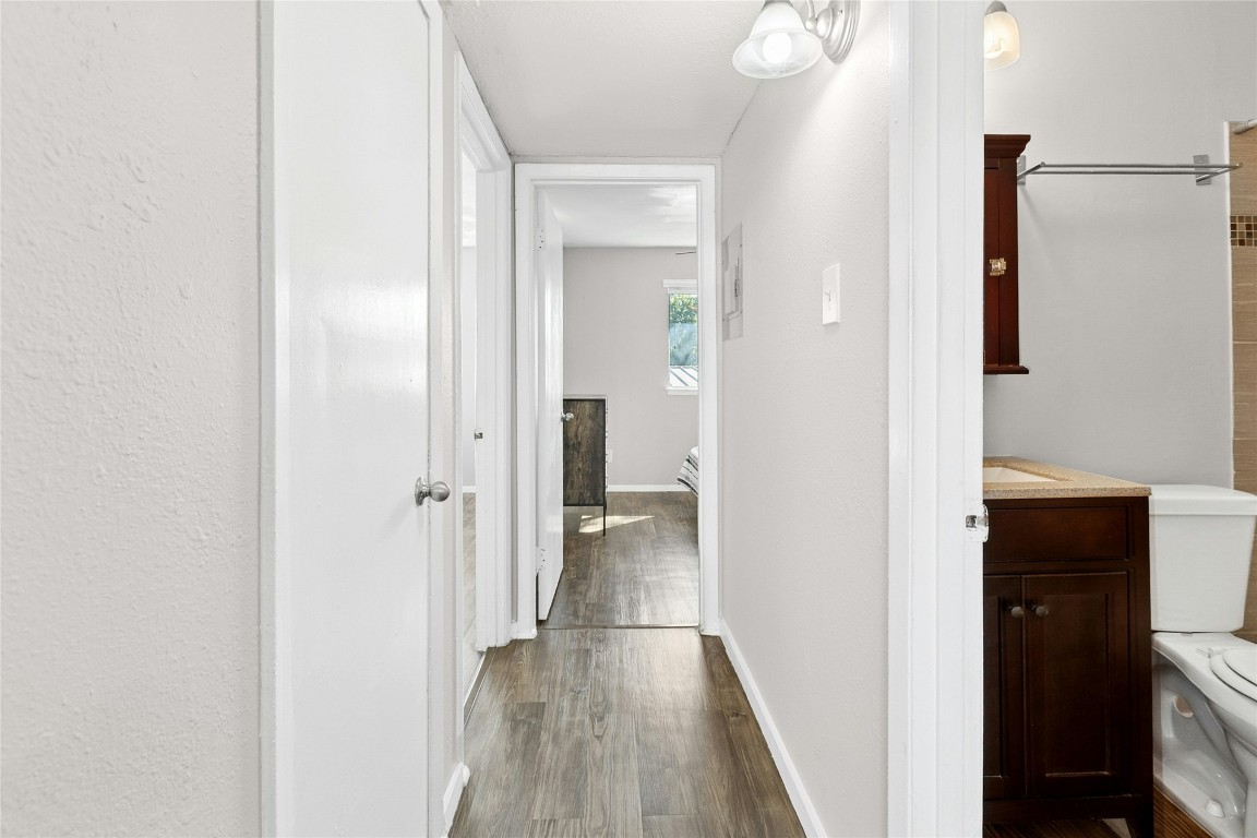 2401 Manor Road, Unit 214 Austin, TX 78722 - Photo 22 of 30 Hall with dark wood finished floors and baseboards