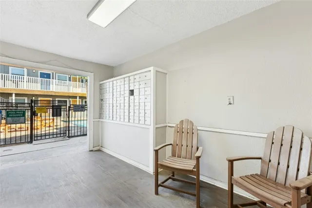 a view of a patio with couches table and chairs with wooden floor