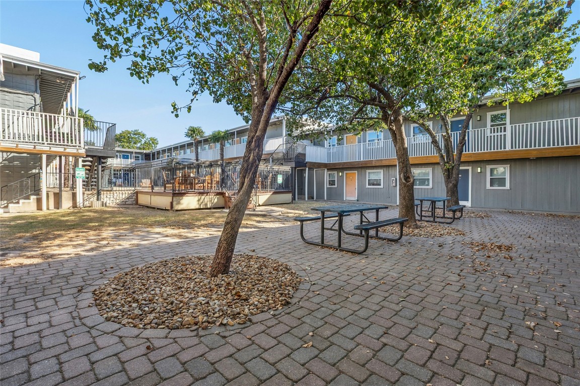 2401 Manor Road, Unit 214 Austin, TX 78722 - Photo 24 of 30 Surrounding community featuring a patio, a wooden deck, and stairs