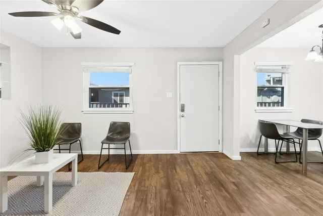 a living room with furniture and a potted plant