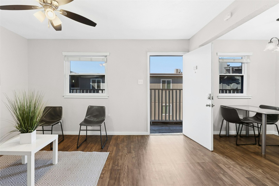 2401 Manor Road, Unit 214 Austin, TX 78722 - Photo 4 of 30 Sitting room featuring dark wood finished floors, healthy amount of natural light, and ceiling fan