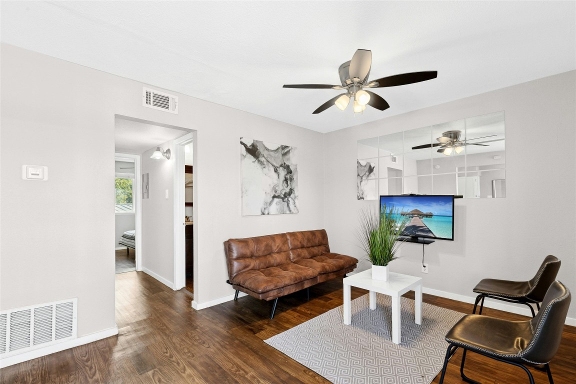 2401 Manor Road, Unit 214 Austin, TX 78722 - Photo 7 of 30 Living room with dark wood-style flooring and a ceiling fan