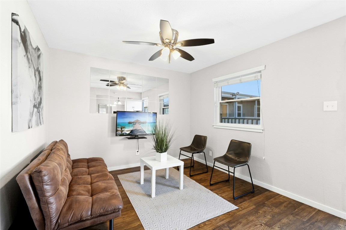 2401 Manor Road, Unit 214 Austin, TX 78722 - Photo 9 of 30 Living area featuring dark wood finished floors and a ceiling fan