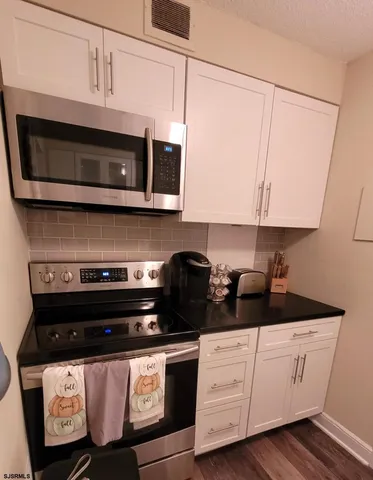 a room with a sink and cabinets
