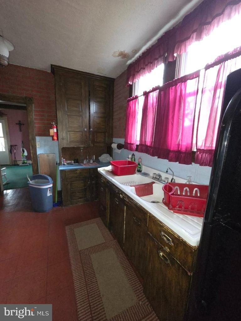132 Mayfair Road Paxinos, PA 17860 - Photo 16 of 17 a kitchen with stainless steel appliances a sink dishwasher and a view of living room