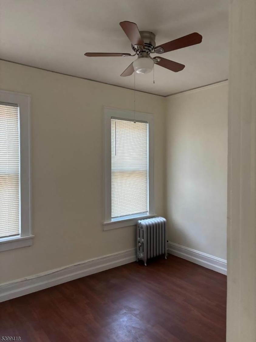 931 Madison Avenue Elizabeth, NJ 07201 - Photo 17 of 23 a view of an empty room with a window and wooden floor