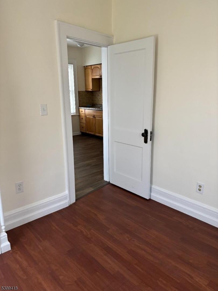 931 Madison Avenue Elizabeth, NJ 07201 - Photo 19 of 23 wooden floor in an empty room