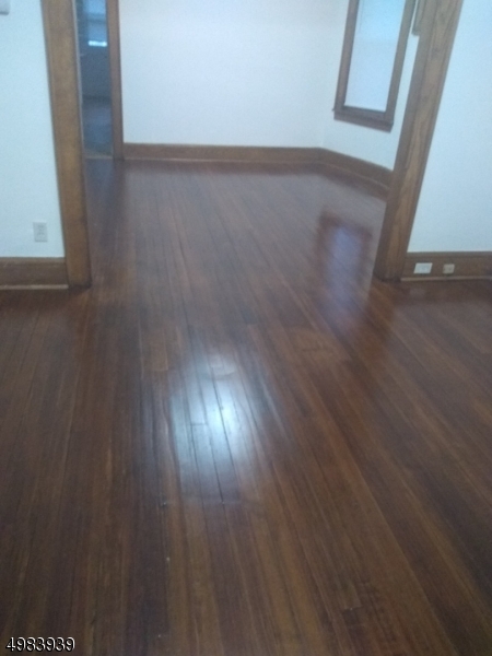 931 Madison Avenue Elizabeth, NJ 07201 - Photo 4 of 23 a view of an empty room and wooden floor