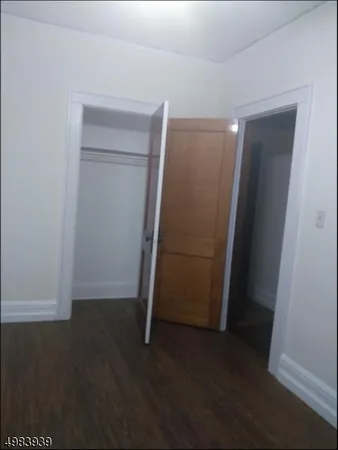 an empty room with wooden floor