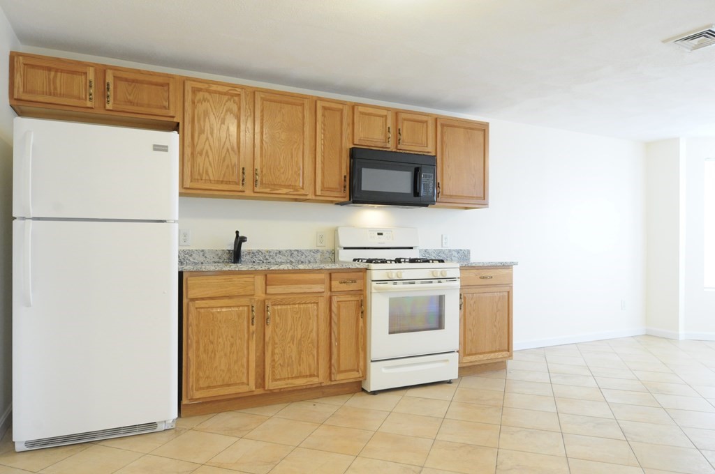 174 Maverick Street, Unit 3 Boston, MA 02128 - Photo 1 of 10 a kitchen with stainless steel appliances granite countertop a refrigerator stove top oven and sink