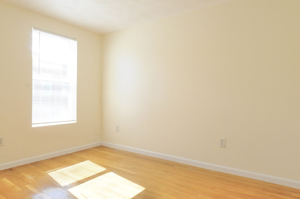 174 Maverick Street, Unit 3 Boston, MA 02128 - Photo 3 of 10 an empty room with a window