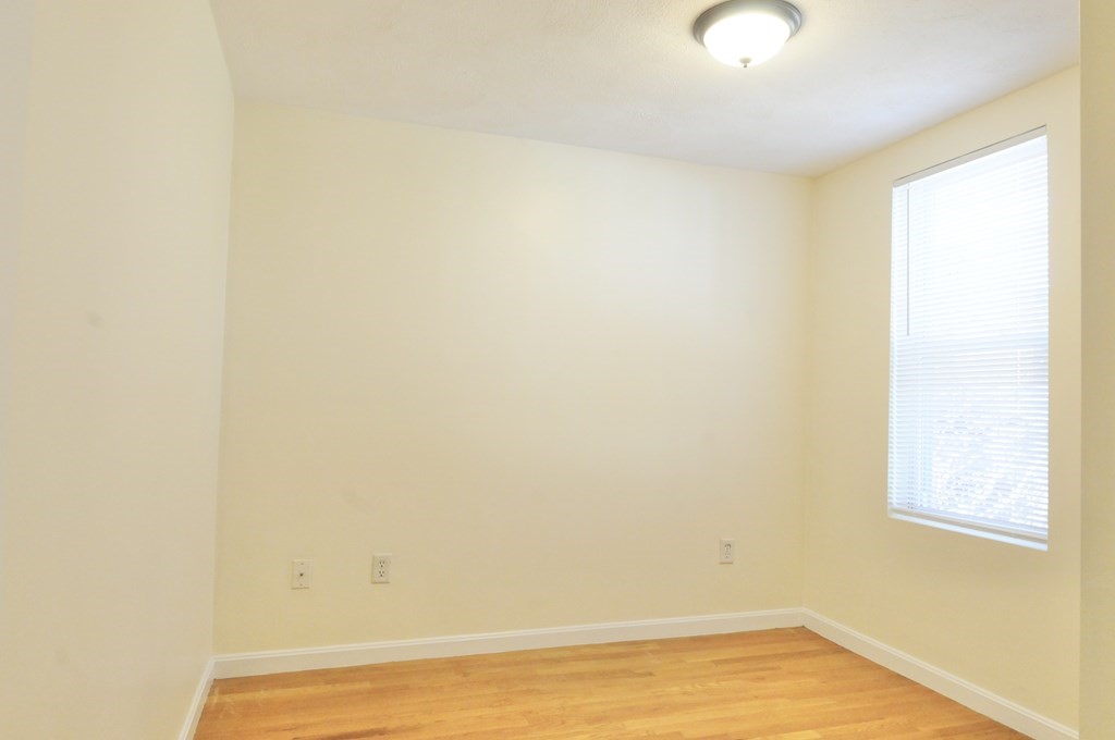 174 Maverick Street, Unit 3 Boston, MA 02128 - Photo 5 of 10 a view of a small space with wooden floor and a window