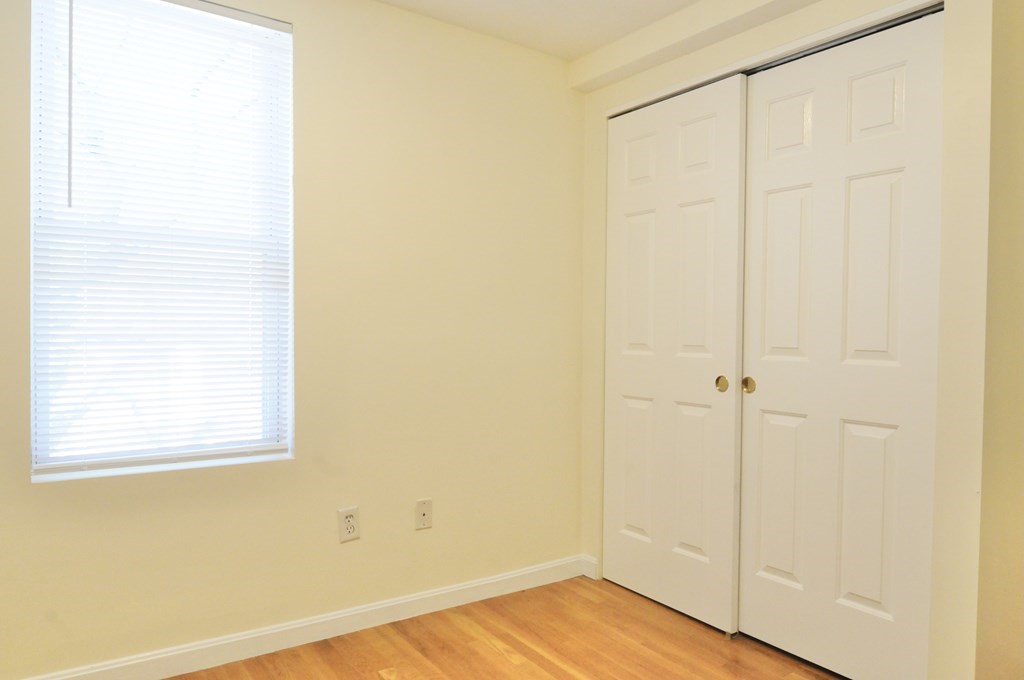 174 Maverick Street, Unit 3 Boston, MA 02128 - Photo 6 of 10 a view of a small space with wooden floor and a window
