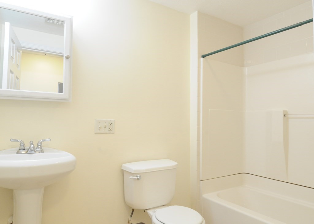 174 Maverick Street, Unit 3 Boston, MA 02128 - Photo 7 of 10 a bathroom with a sink a toilet and shower