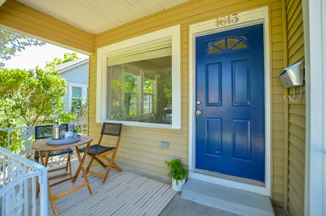 a view of a house with a porch and furniture