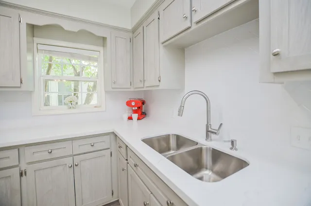 a close view of a sink and a cabinet in a kitchen