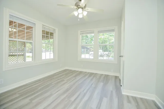 wooden floor in an empty room with a window