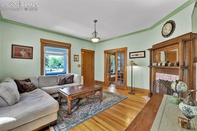 a living room with furniture a flat screen tv and a table