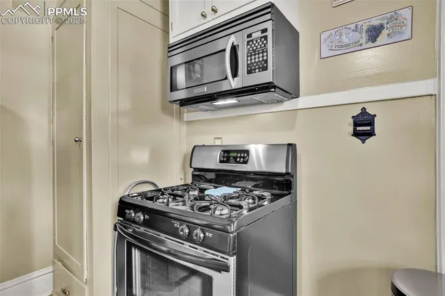 a stove top oven sitting inside of a kitchen